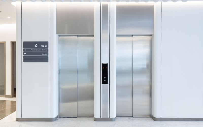 Blank silver closed elevator in office floor interior